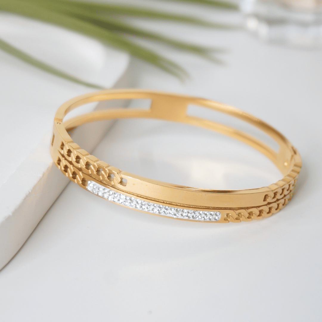 Gold bracelet with diamond accents on a light surface